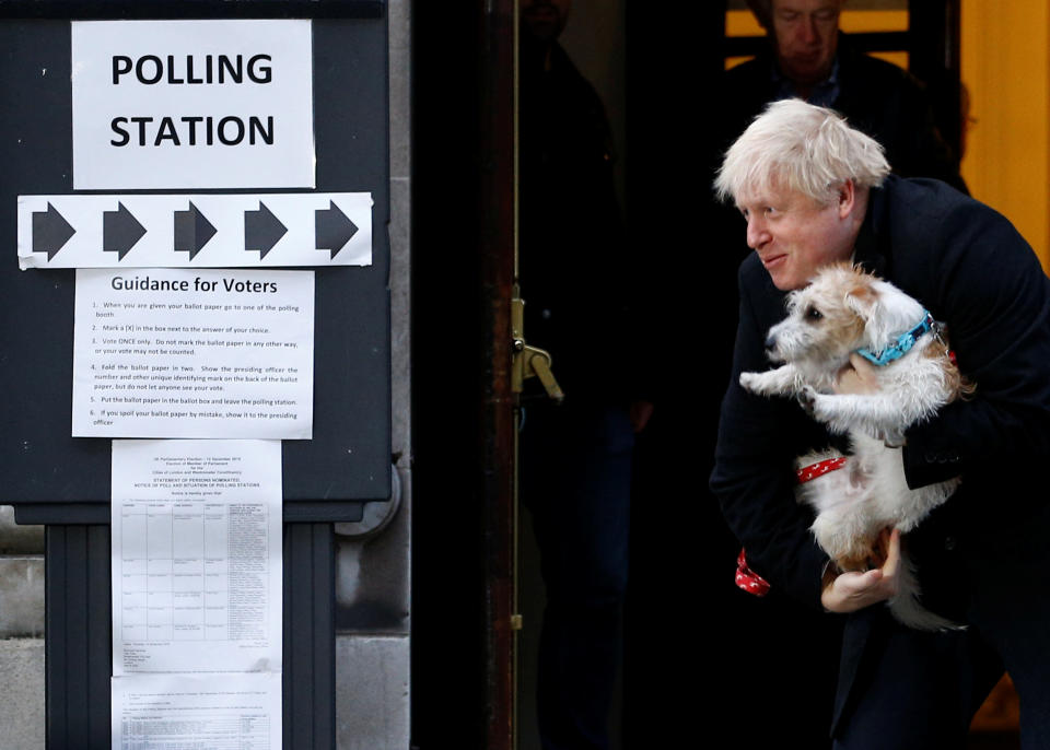 Britain's Prime Minister Boris Johnson leaves a polling station at the Methodist Central Hall, with his dog Dilyn, after voting in the general election in London, Britain, December 12, 2019. REUTERS/Henry Nicholls