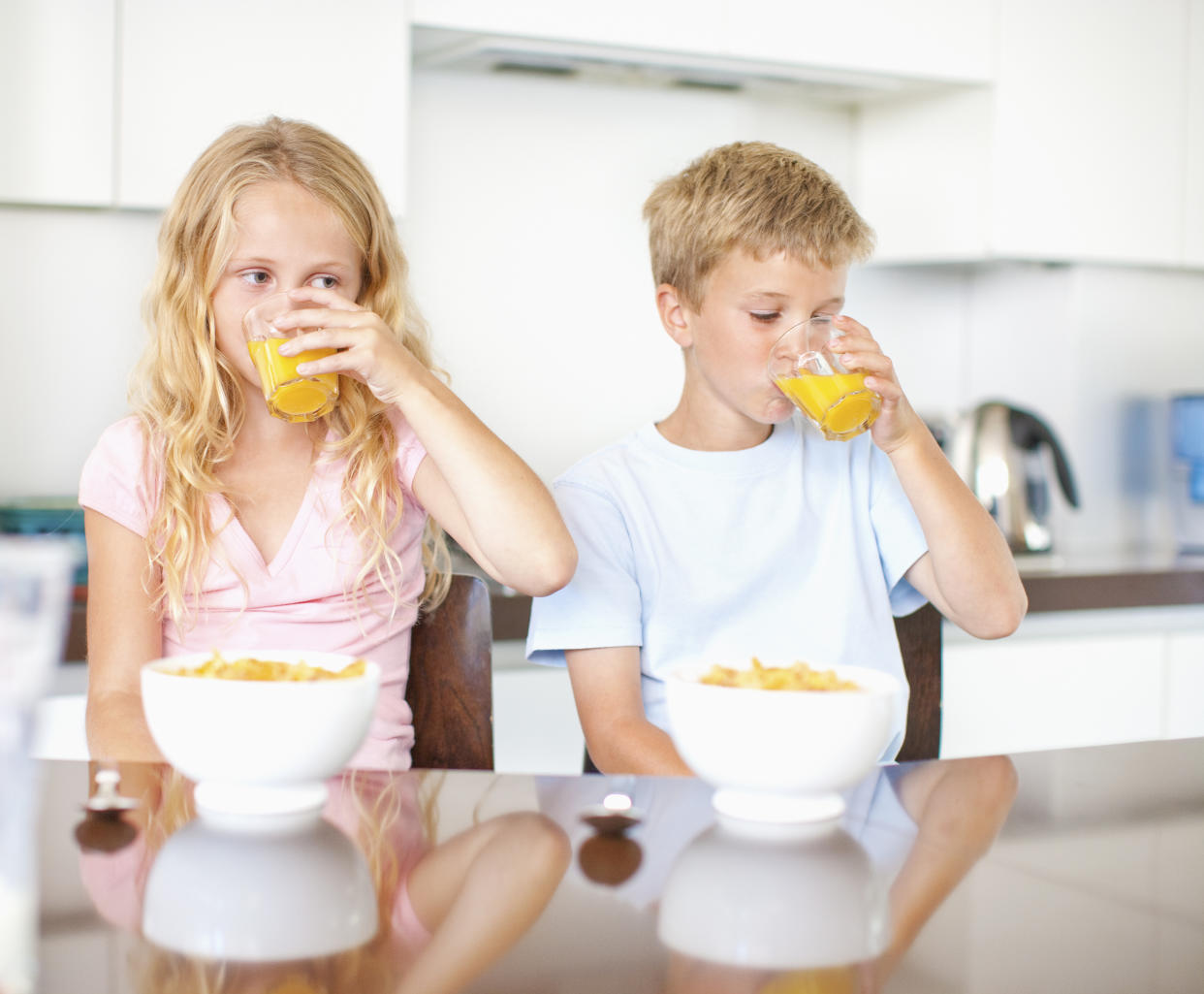 Children having breakfast of cereal and juice sugar. (Getty Images)