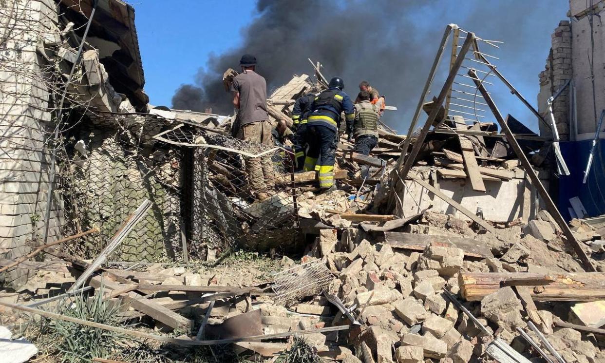 <span>Rescuers go through a building destroyed by a Russian airstrike in the north-eastern Ukrainian village of Lyptsi, which killed three people.</span><span>Photograph: Oleh Syniehubov/Telegram/Reuters</span>