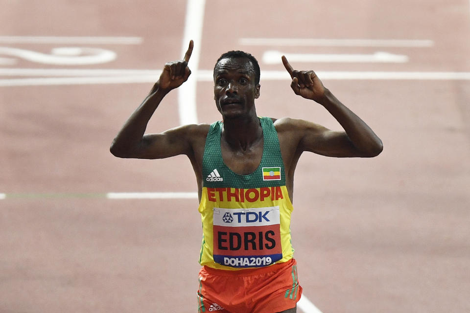 Muktar Edris, of Ethiopia, celebrates after winning the gold medal in the men's 5000 meter final during the World Athletics Championships in Doha, Qatar, Monday, Sept. 30, 2019. (AP Photo/Martin Meissner)