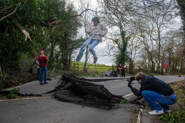Skateboarders use the landslide-damaged B4069 in Lyneham (Adam Hughes/SWNS)