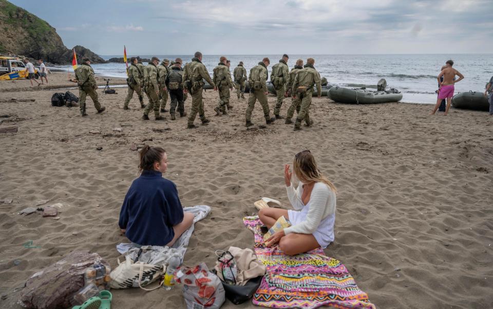 A beach picnic with an unusual view, 47 Commando having landed their raiding crafts