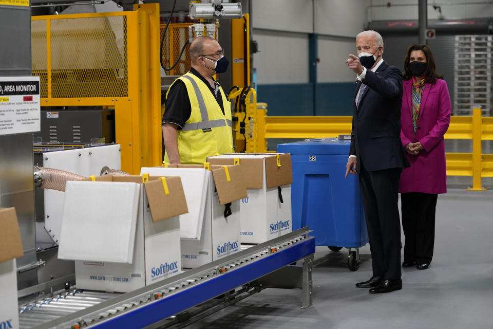 President Joe Biden and Michigan Gov. Gretchen Whitmer, right, tour a Pfizer manufacturing site, Friday, Feb. 19, 2021, in Portage, Mich. (AP Photo/Evan Vucci)