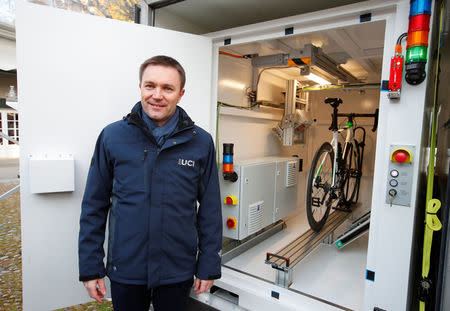 David Lappartient, President of the International Cycling Union (UCI) poses next to the x-ray machine after a news conference on the fight against technological fraud in Geneva, Switzerland March 21, 2018. REUTERS/Denis Balibouse