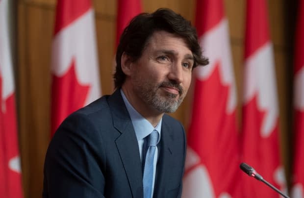 Prime Minister Justin Trudeau during a news conference earlier this month. He previously challenged political rivals to possibly intervene in a legal battle against Quebec's secularism law but now says his minority government will observe the situation closely.  (Adrian Wyld/The Canadian Press - image credit)