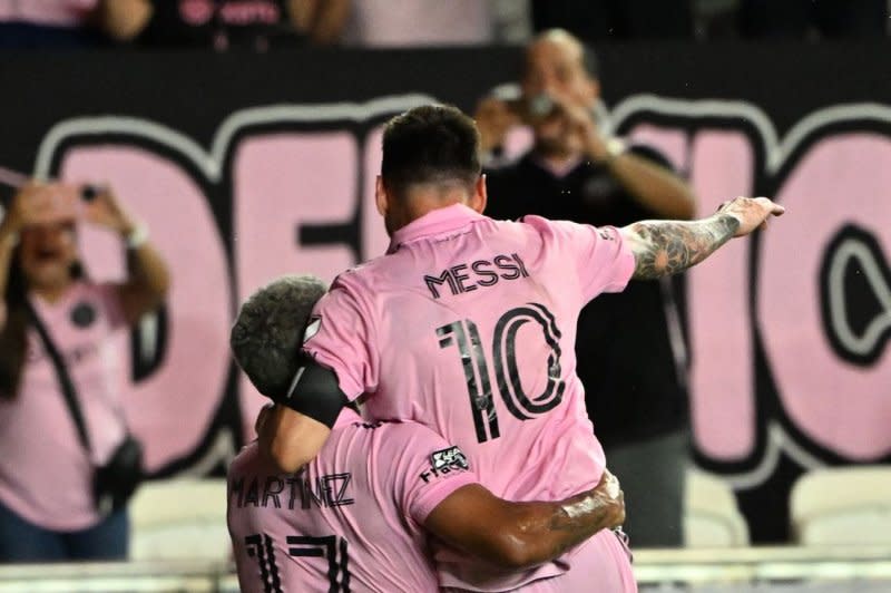 Lionel Messi (R) jumps into Inter Miami teammate Josef Martinez in celebration after making a game-winning free against Cruz Azul on Friday at DRV PNK Stadium in Fort Lauderdale, Fla. Photo by Larry Marano/UPI