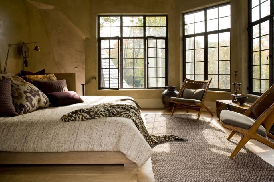 <p>Natural light fills this bedroom, while warm colors and plush textures create an inviting space. Design by <a href="https://deringhall.com/interior-designers/glenn-gissler" rel="nofollow noopener" target="_blank" data-ylk="slk:Glenn Gissler;elm:context_link;itc:0;sec:content-canvas" class="link ">Glenn Gissler</a>.</p>