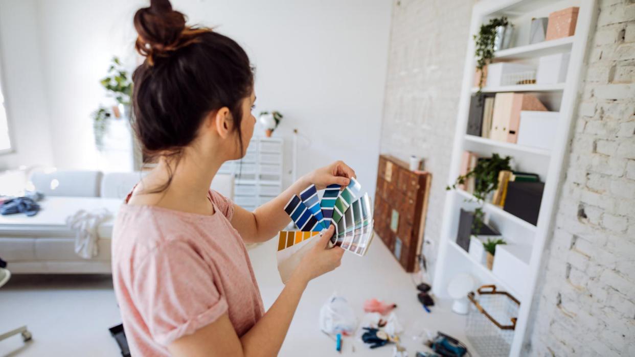 A woman choosing the right color for the wall