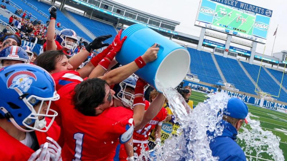 Christian Academy-Louisville players give head coach Hunter Cantwell an ice-cold celebratory bath after winning the Class 3A championship for the second year in a row.