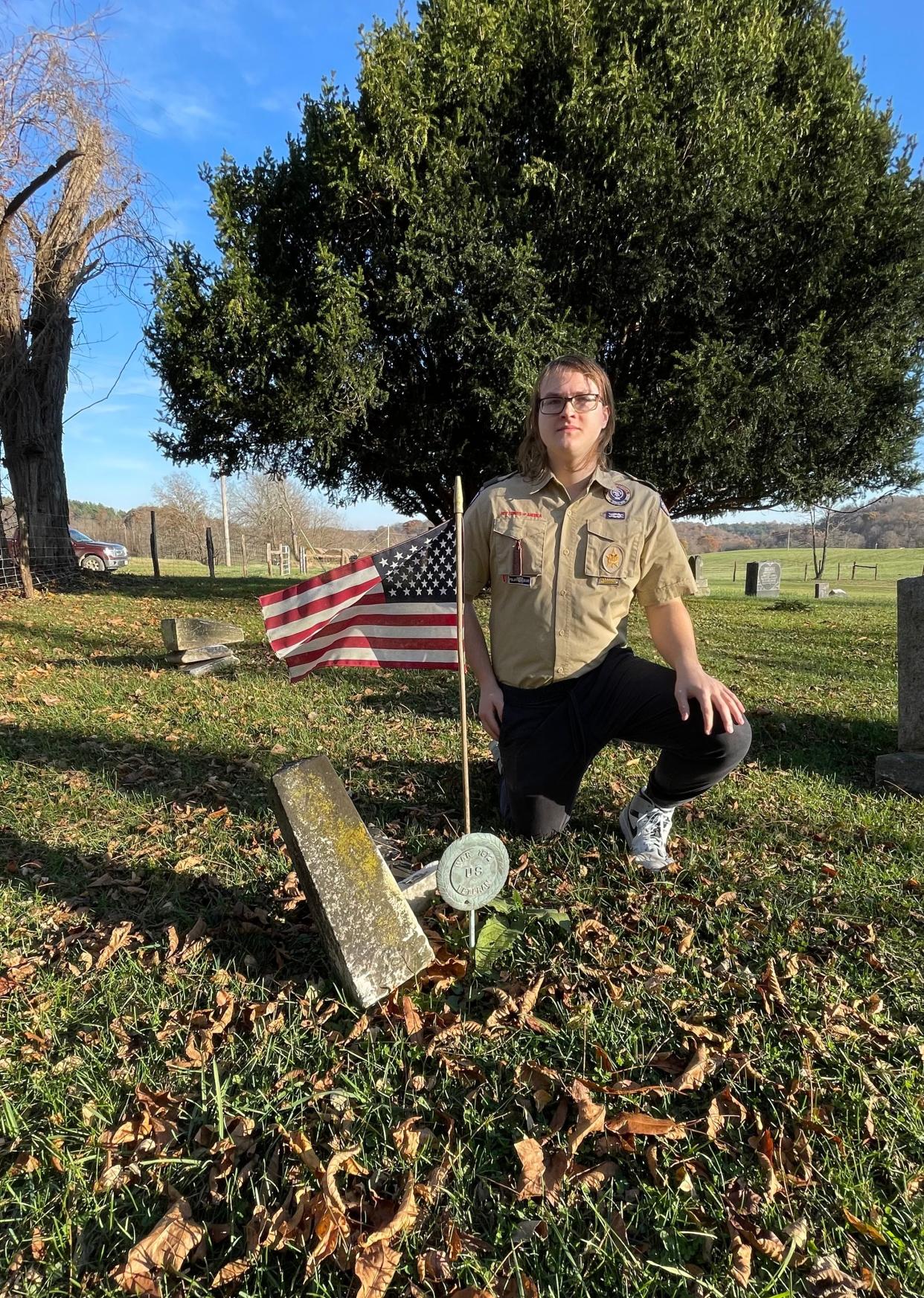Matthew G. Beamer of Scout Troop 5429 poses in the Grove Methodist Episcopal Cemetery, which he recently helped restore as an Eagle Scout Project.