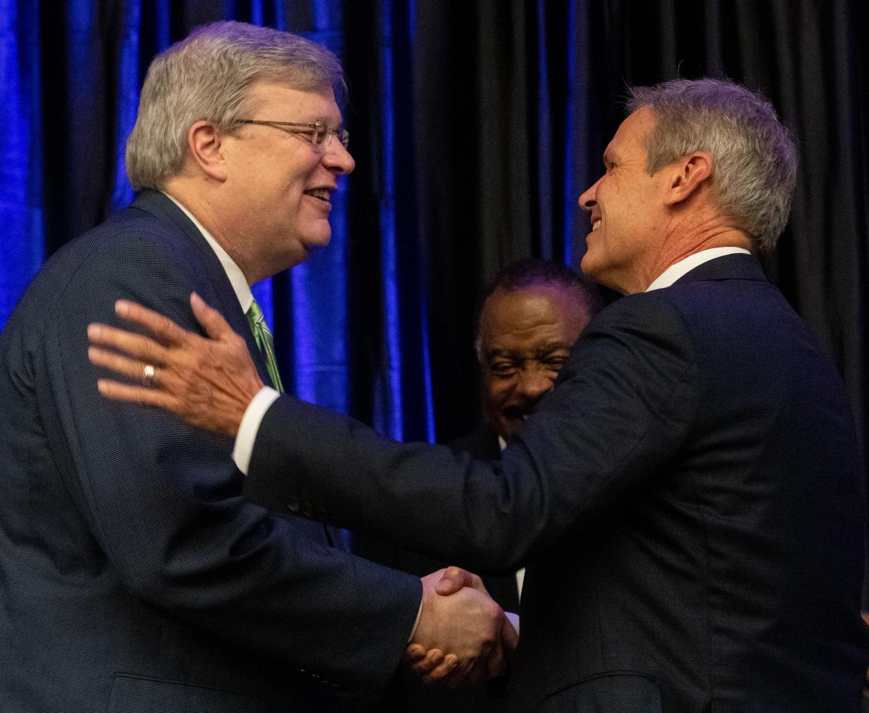 Tennessee Gov. Bill Lee shakes hands with Memphis Mayor Jim Strickland at the 2022 MMBC Continuum Economic Development Forum on Wednesday, Aug. 24, 2022, at the Renasant Convention Center in Memphis.