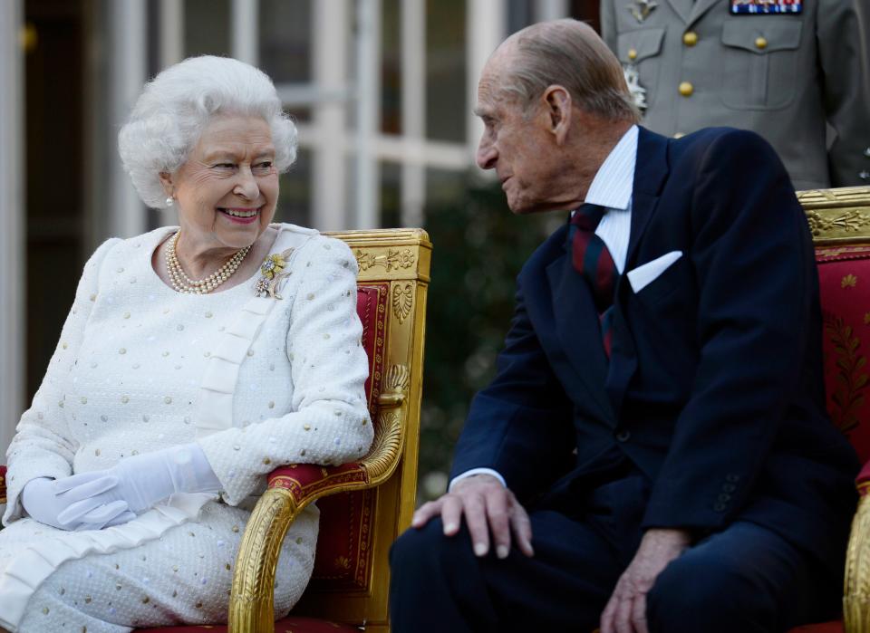 Queen Elizabeth II and the Duke of Edinburgh attending a garden party in Paris in 2014 (PA)