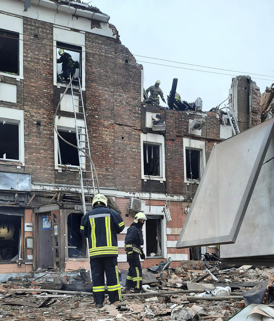 In this photo provided by the Ukrainian Police Press Office, emergency workers search for victims of the Russian rocket attack that damaged a multi-storey building in central Kharkiv, Friday, Oct. 6, 2023. (Ukrainian Police Press Office via AP)