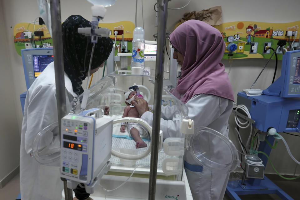 Palestinian doctors treat a prematurely born baby at Al Aqsa Hospital in Deir el-Balah, Gaza Strip, Sunday, Oct. 22, 2023. (AP Photo/Adel Hana)