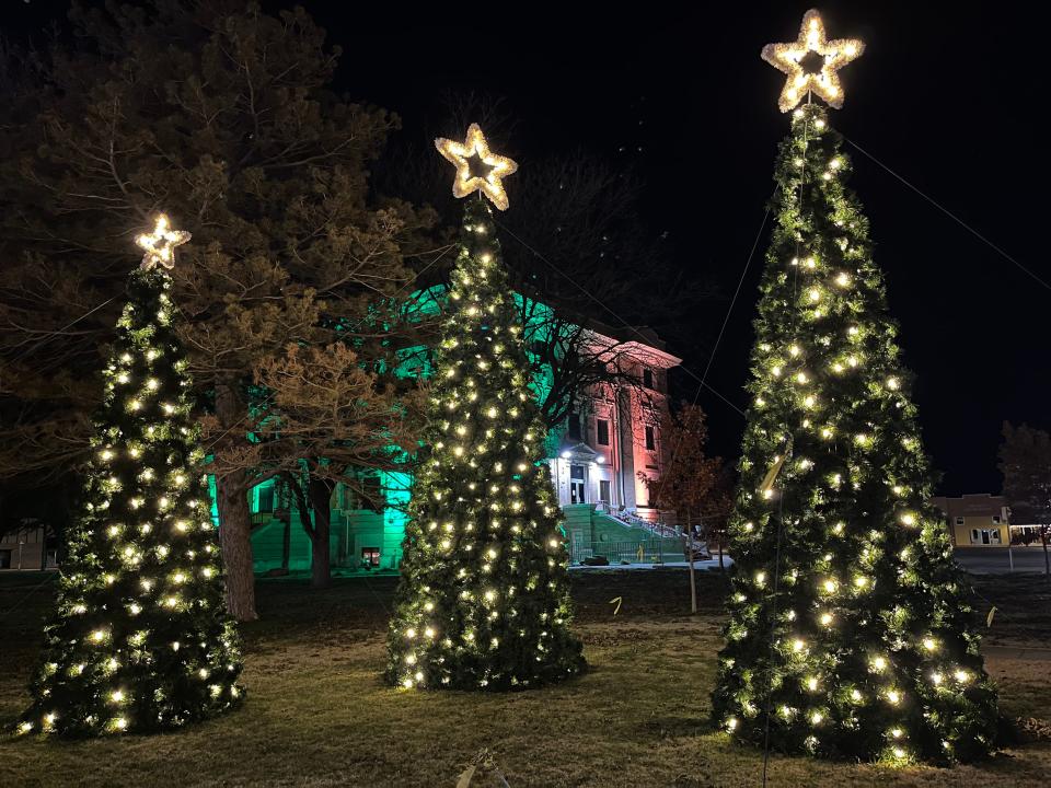 Plainview's community Christmas trees decorate the Hale County Courthouse lawn Wednesday night.