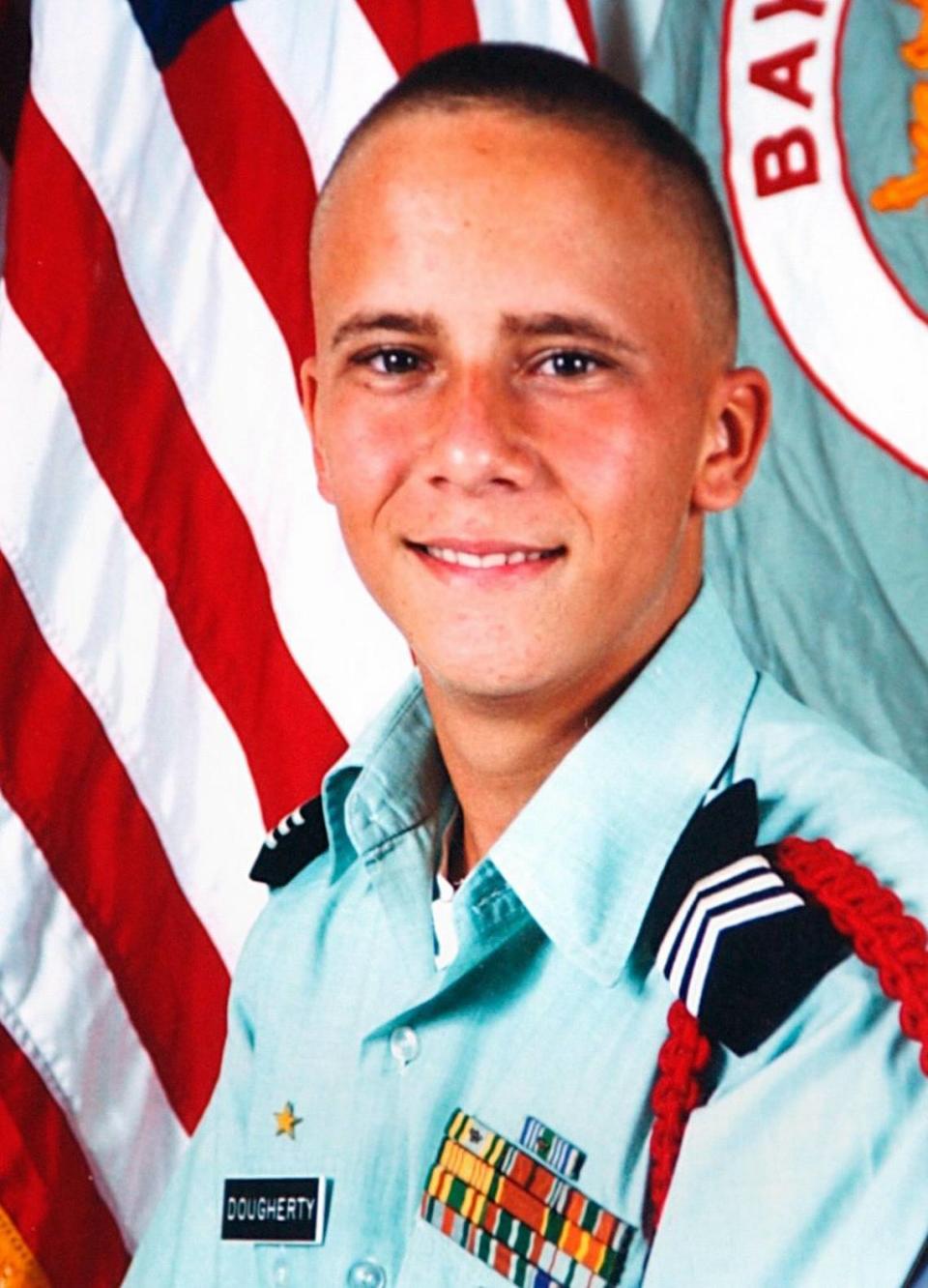 A photo of Lance Cpl. Scott Dougherty appears in a memorial collage at Griffith-Cline Funeral Home on Friday afternoon, July 16, 2004, in Bradenton during a visitation for family and friends of the fallen Marine from Bayshore High.