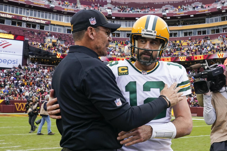 Washington Commanders head coach Ron Rivera, left, talks with Green Bay Packers quarterback Aaron Rodgers after an NFL football game Sunday, Oct. 23, 2022, in Landover, Md. (AP Photo/Susan Walsh)