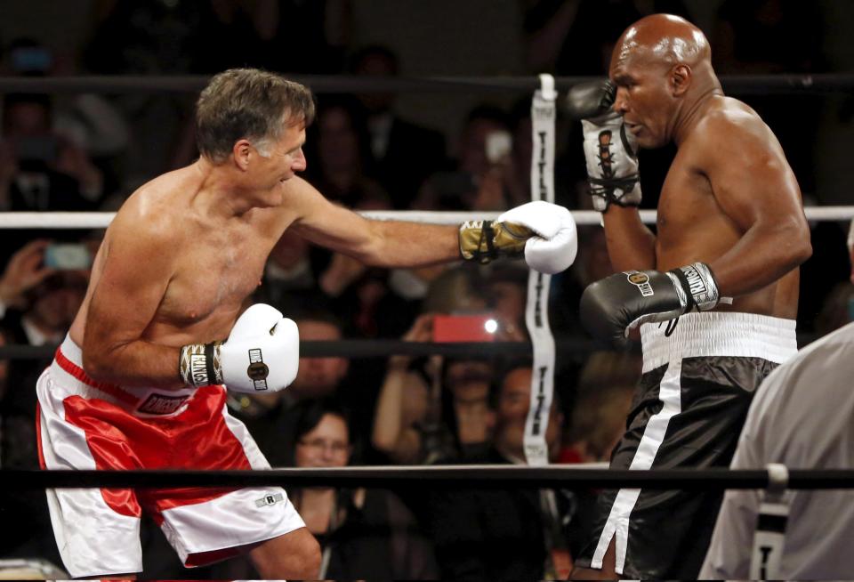 Former Massachusetts Governor and two-time presidential candidate Mitt Romney fights five-time heavyweight champion Evander Holyfield during their boxing match in Salt Lake City, Utah