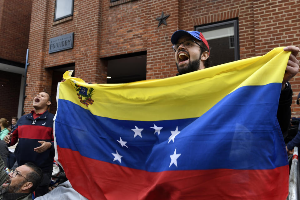 Protester Andres Miguel Harris, who was born in Venezuela, protests with other outside the Venezuelan embassy in Washington, Tuesday, May 14, 2019. (AP Photo/Susan Walsh)