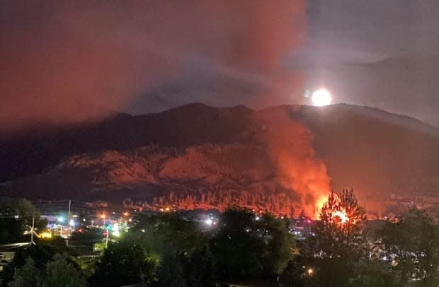 A fire at the Sacred Heart Church on Penticton Indian Band lands is seen burning early on June 21. The building was destroyed in the fire, as was a separate church that burned on Osoyoos Indian Band lands around the same time. (Aileen Macasaet Maningas/Facebook - image credit)