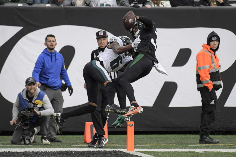 New York Jets cornerback Bryce Hall (37) breaks up a pass to Philadelphia Eagles wide receiver DeVonta Smith (6) during the second half of an NFL football game, Sunday, Dec. 5, 2021, in East Rutherford, N.J. (AP Photo/Bill Kostroun)