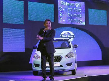 Kenichiro Yomura, President of Nissan Motor India, gestures in front of a "Datsun GO" car while speaking with the reporters during its launch in New Delhi March 19, 2014. REUTERS/Anindito Mukherjee