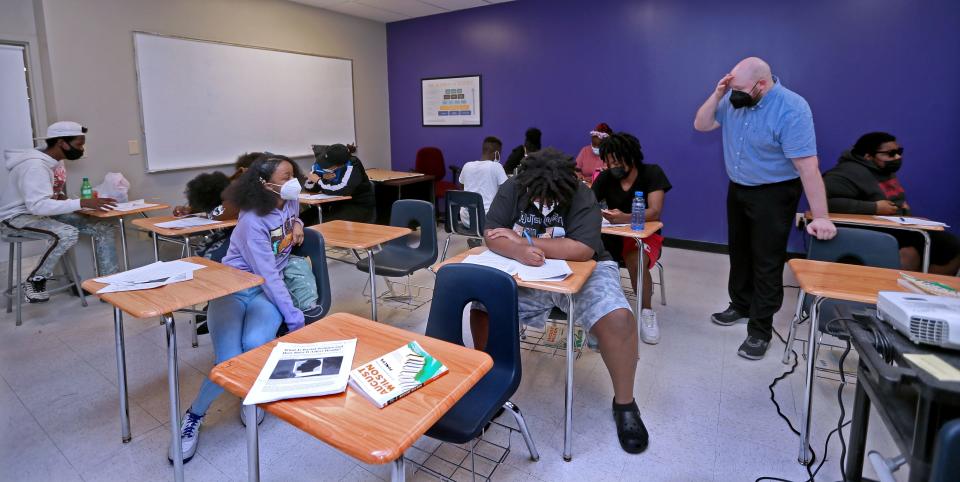 Marcus Westphal, second from right, teaches a summer school English class at Dr. Howard Fuller Collegiate Academy in Milwaukee. The school plans to move into a larger location in Milwaukee's Bronzeville neighborhood.