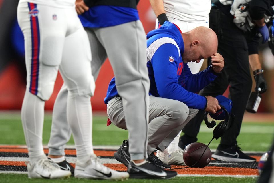 Buffalo Bills head coach Sean McDermott takes a knee as Buffalo Bills safety Damar Hamlin (3) is tended to on the field Monday night.