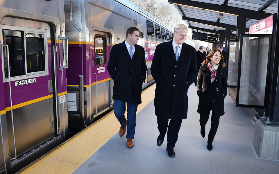 Gov. Charlie Baker and Lt. Gov. Karyn Polito arrive by train for the South Coast Rail project ribbon cutting Monday at the Freetown Station.