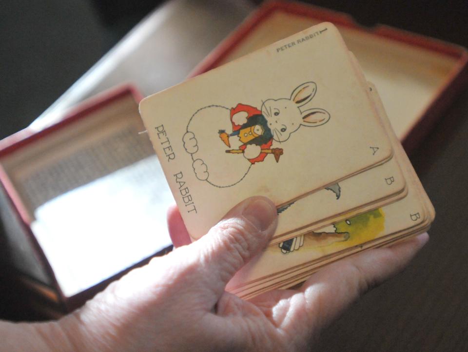 Sandwich town archivist and reference librarian Deborah Rich holds the Peter Rabbit card that is part of the Hoot card game with the characters from Thornton Burgess' books. This card game will be part of a display on Thornton Burgess and is part of the town's archives. Sandwich is celebrating the 150th birthday year of renowned author and conservationist Thornton Burgess, a Sandwich native.