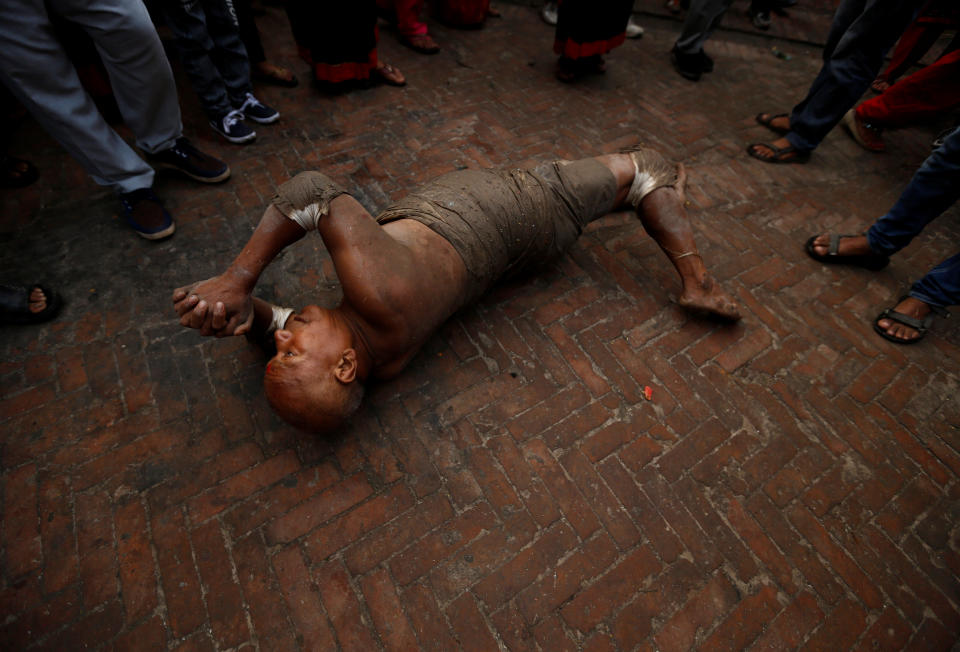 <p>A devotee offers prayer by rolling on the ground during “Dashain”, a Hindu religious festival in Bhaktapur, Nepal, Sept. 30, 2017. (Photo: Navesh Chitrakar/Reuters) </p>