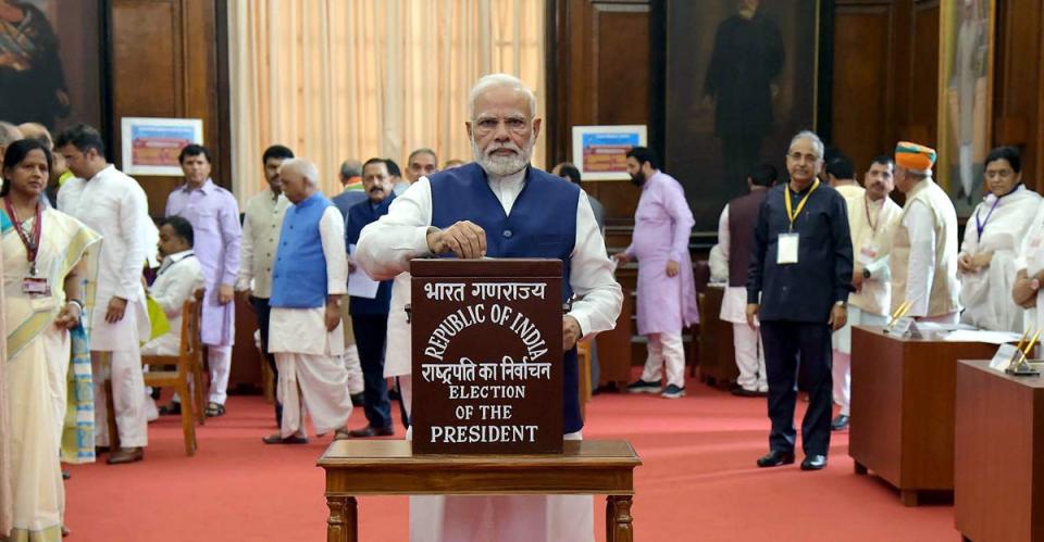 Narendra Modi casts his vote in the 2022 Indian presidential election on Monday (EPA)