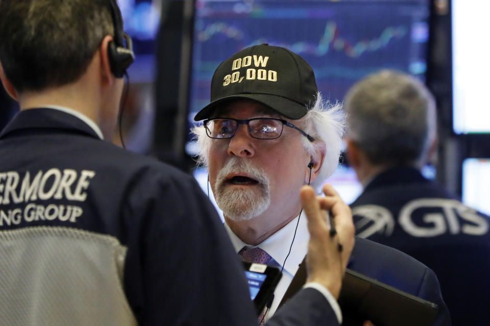 Trader Peter Tuchman wears a "Dow 30,000" cap as he works on the floor of the New York Stock Exchange, Wednesday, March 4, 2020. (AP Photo/Richard Drew)