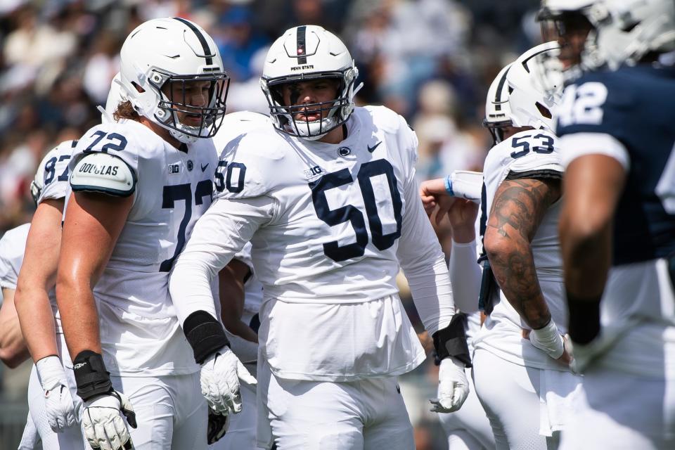 Penn State offensive linemen Cooper Cousins (50) and Nolan Rucci (72) talk before a play during the Blue-White game at Beaver Stadium on Saturday, April 13, 2024, in State College. Cousins may be the most advanced true freshman blocker in coach James Franklin's decade at PSU.