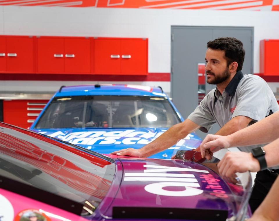 Hendrick Motorsports crew member Reuben Kauffman works on one of Alex Bowman's cars in the team's shop in Concord, North Carolina.