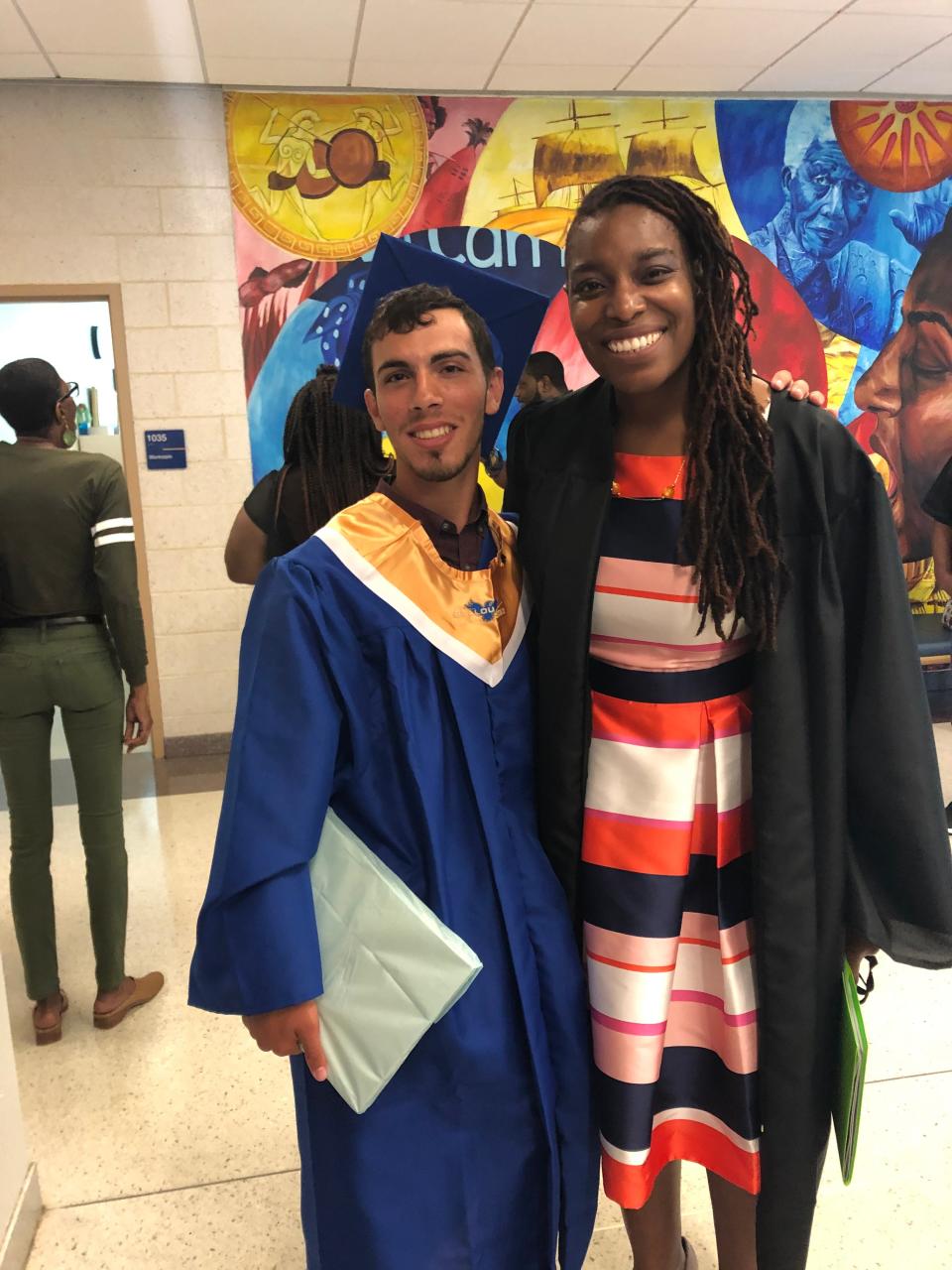 Yaakov Ben-David, dressed for graduation, poses with his high school principal, Cara Fuller.