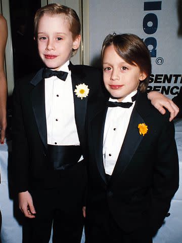 <p>Dave Benett/Getty</p> Macaulay Culkin with his brother Kieran Culkin in 1991