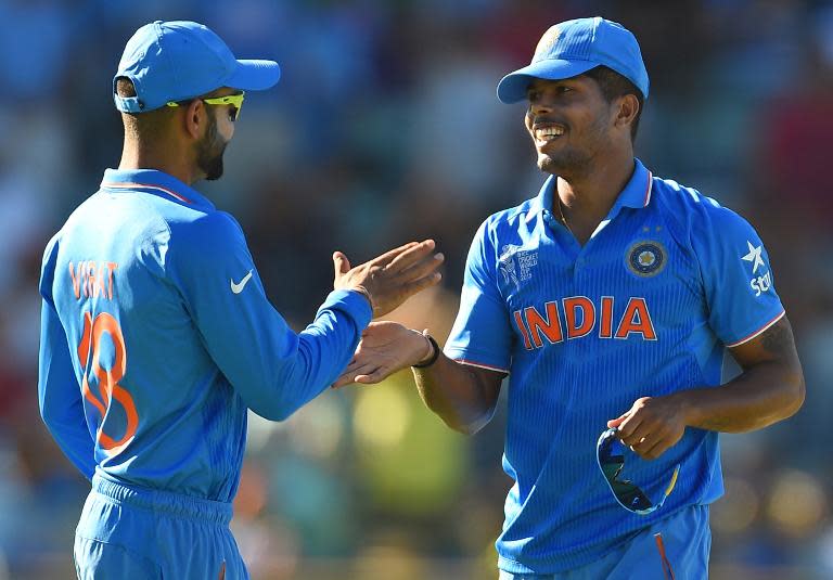 India's Umesh Yadav (R) celebrates with teammate Ravindra Jadeja after they dismissed the United Arab Emirates for 102 during the World Cup Pool B match in Perth on February 28, 2015