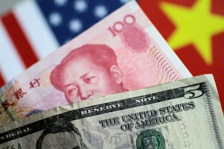 FILE PHOTO: U.S. dollar and China yuan notes are seen in this picture illustration June 2, 2017. REUTERS/Thomas White/Illustration/File Photo