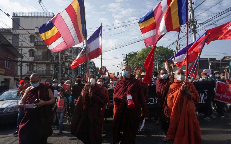 Buddhist monks march with protesters during a demonstration against the military coup in Yangon on Monday - AFP