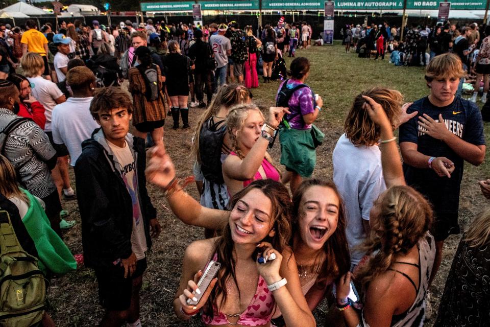 Happy participants form a line to re-enter the 2022 Firefly Music Festival in Dover, Sunday, Sept. 26, 2022