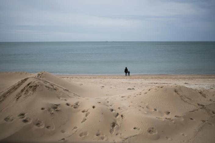 People enjoy a walk on the the beach in La Baule, western France after lockdown measures were eased (AFP Photo/Loic VENANCE)