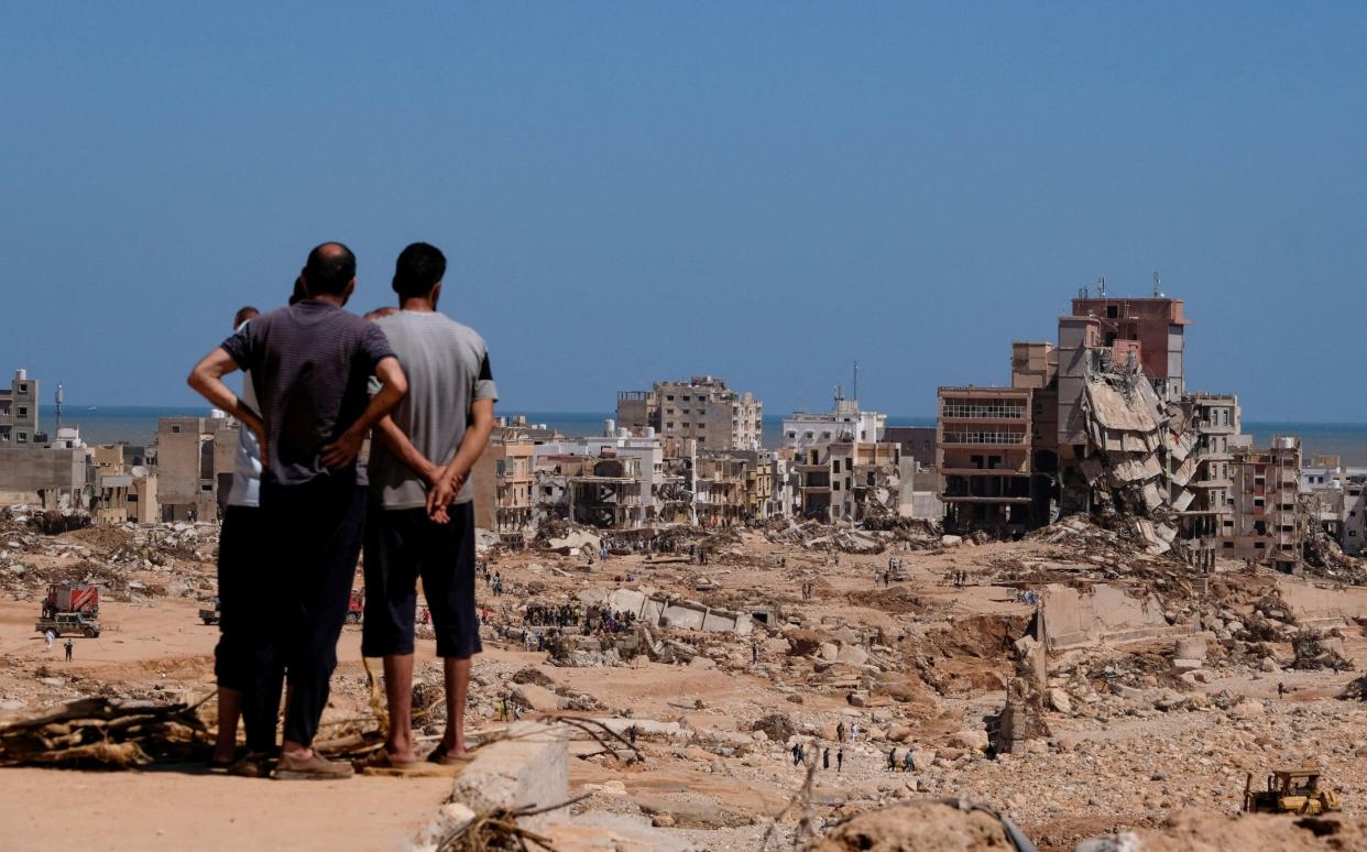 A view shows people looking at the damaged areas, in the aftermath of the floods in Derna, Libya