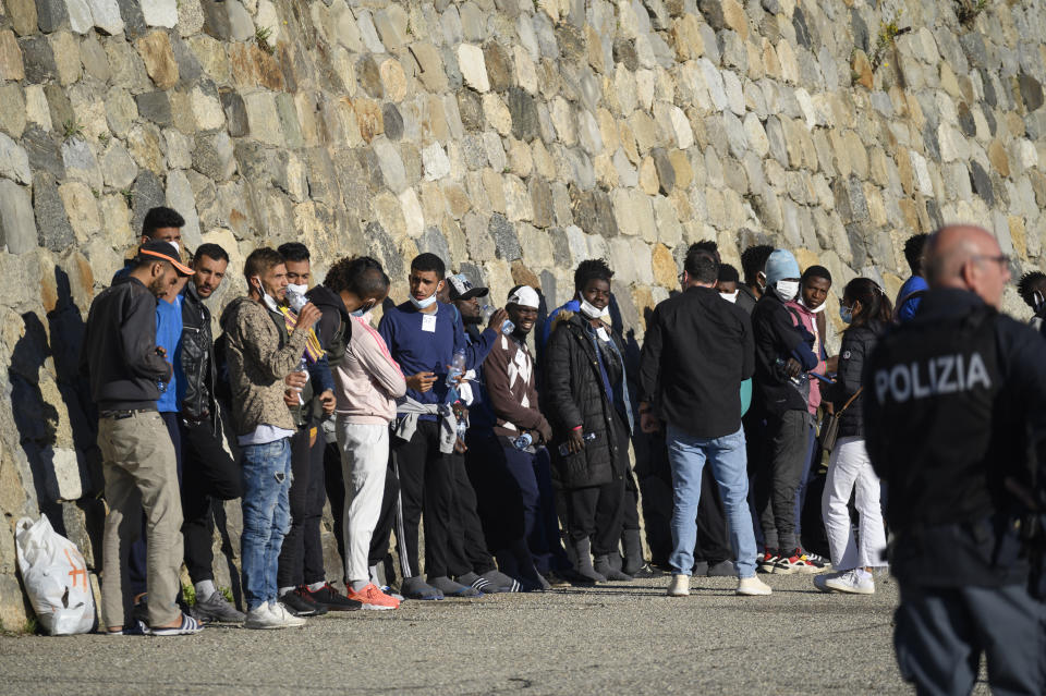 Migrants disembark from the German humanitarian ship Rise Above docked in the southern Italian port town of Reggio Calabria, Tuesday, Nov. 8, 2022.German humanitarian group Mission Lifeline said its ship docked in southern Italy early Tuesday and disembarked the 89 people it had rescued in the central Mediterranean. (AP Photo/Valeria Ferraro)