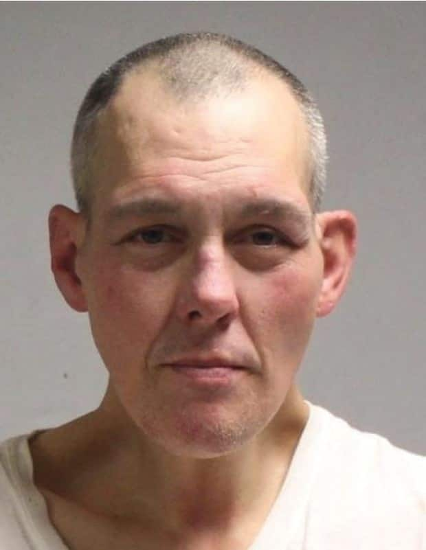 Yves Castonguay, 47, is wanted on a B.C.-wide warrant after failing to appear in court on charges of public incitement of hatred and mischief to property, the Vancouver Police Department said. (Vancouver Police Department - image credit)