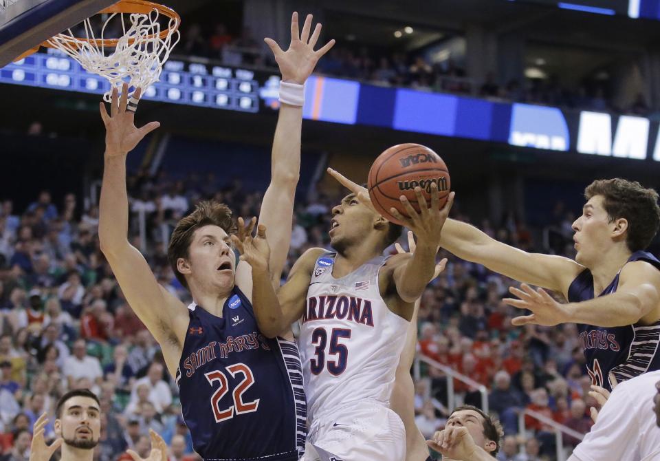 <p>Arizona guard Allonzo Trier (35) goes to the basket as Saint Mary’s Dane Pineau (22) and Evan Fitzner, right, defend during the first half of a second-round college basketball game in the men’s NCAA Tournament, Saturday, March 18, 2017, in Salt Lake City. (AP Photo/Rick Bowmer) </p>