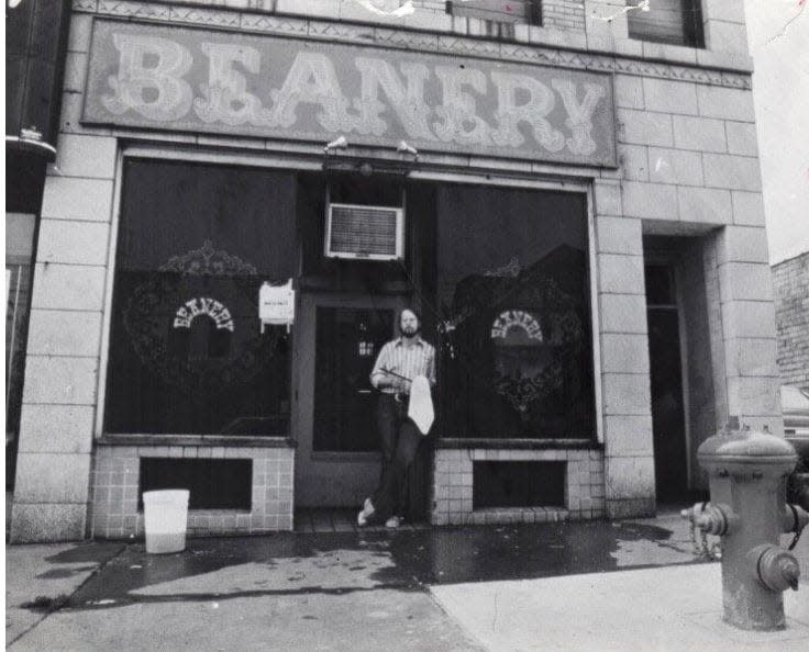 Jim Austin, 22, owner of The Beanery, stands in front of the Spicertown business in 1973 on East Exchange Street between Spicer and Brown streets in Akron.