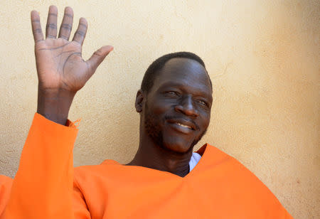 James Gatdet Dak, a former spokesman of the rebel leader Riek Machar, raises his hand as he sits inside the prison in Juba, South Sudan November 2, 2018. REUTERS/Jok Solomun