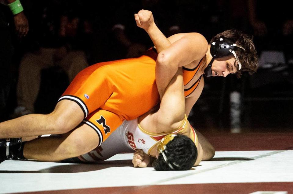 Merced’s Anthony Nixon wrestles Golden Valley’s Raymond Miller during a match at Golden Valley High School in Merced, Calif., on Tuesday, Jan. 23, 2024.