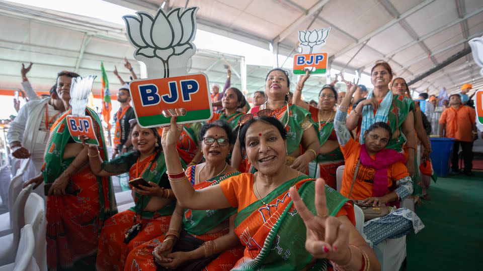 Modi supporters dress in saffron saris, the color of his Bharatiya Janata Party, in Aligarh, India, on April 22, 2024. - John Mees/CNN